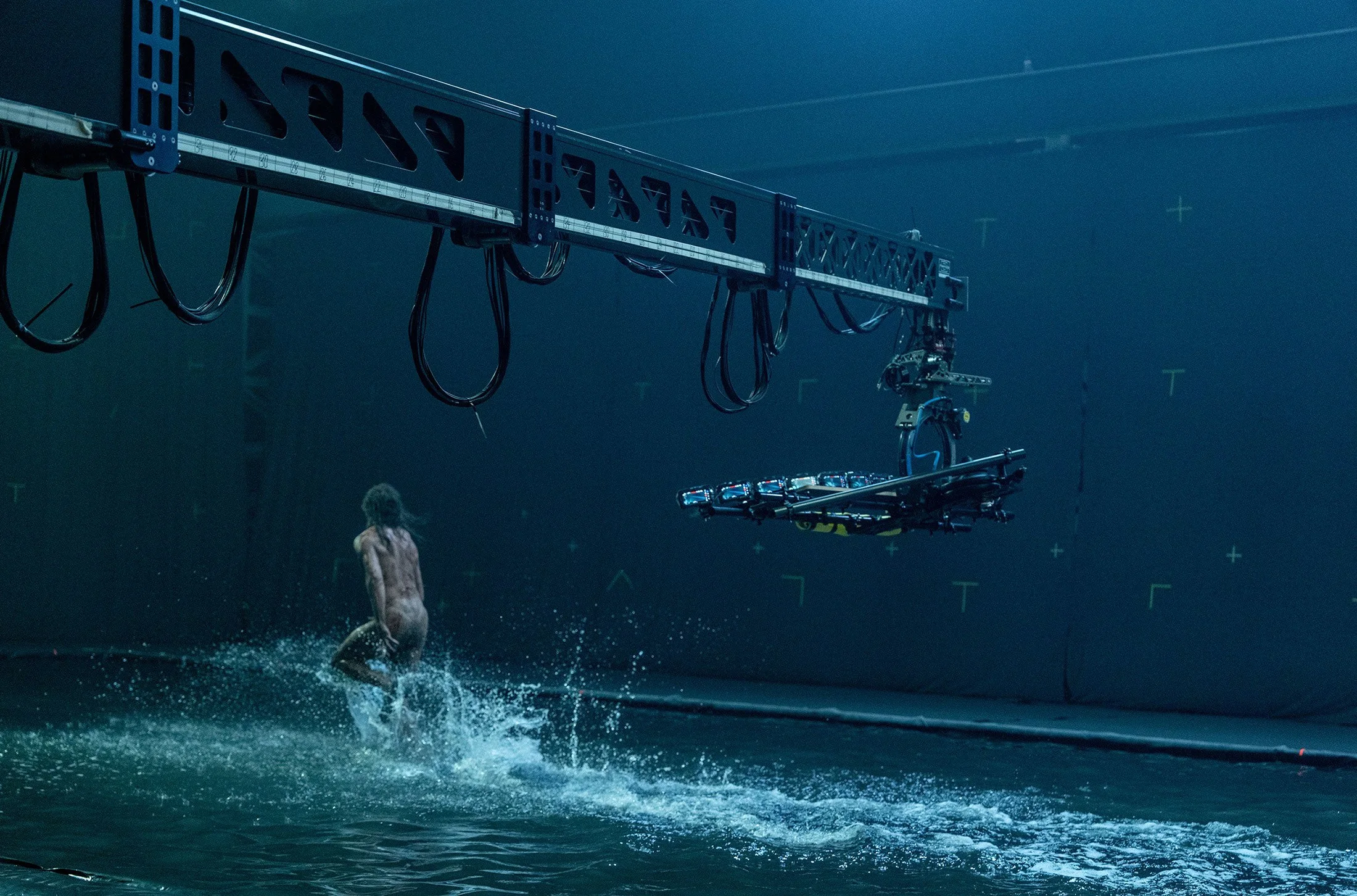 A naked man running through water filmed by a crane-mounted iPhone rig for 28 Years Later.