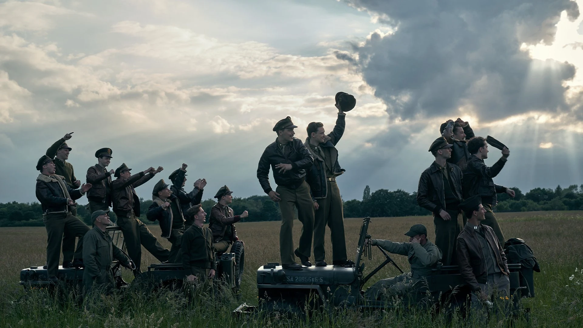Assembled cast from Masters of the Air celebrate during a scene.